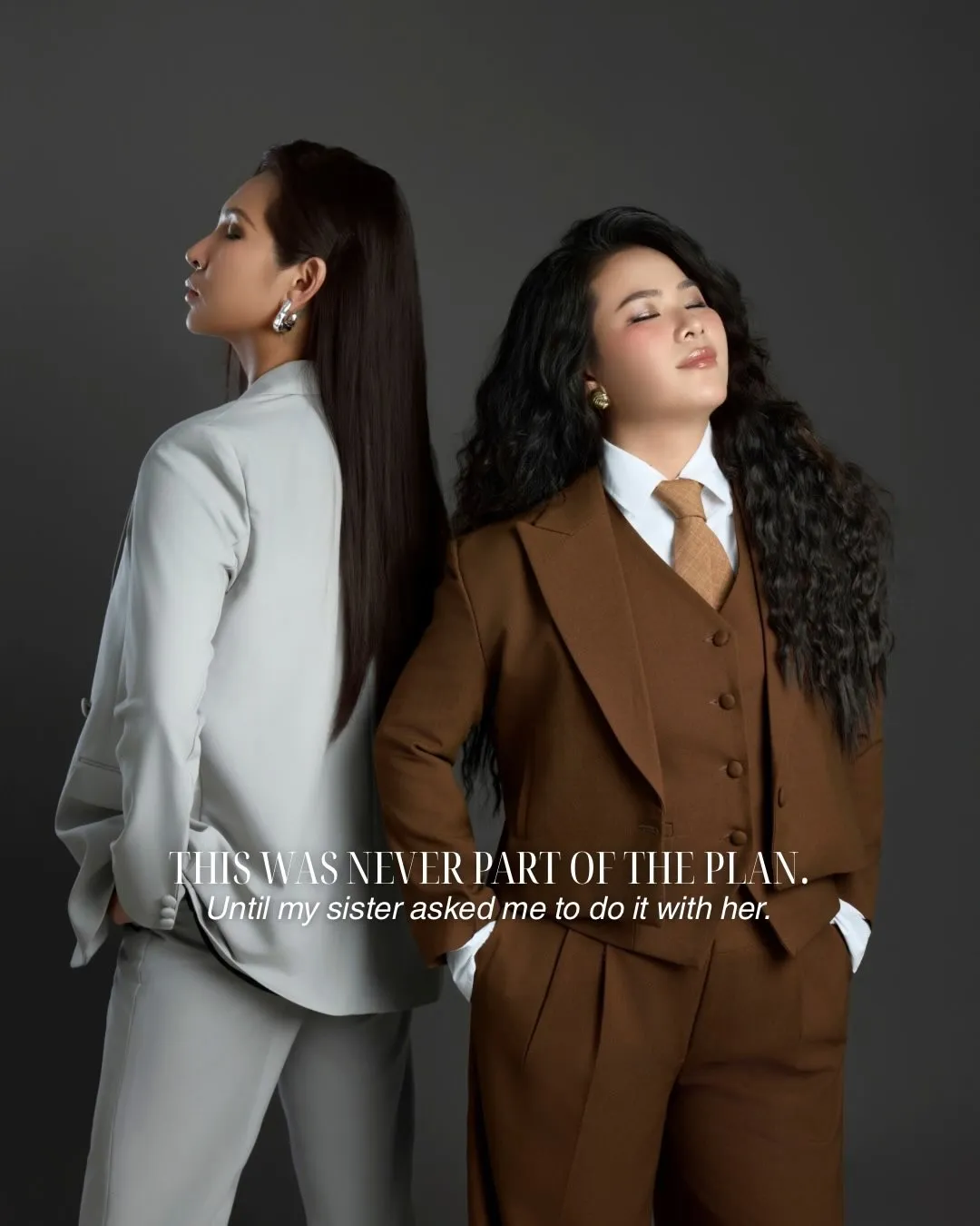 Tiffany and her sister, co-founders of Alpha Media, back to back in tailored suits